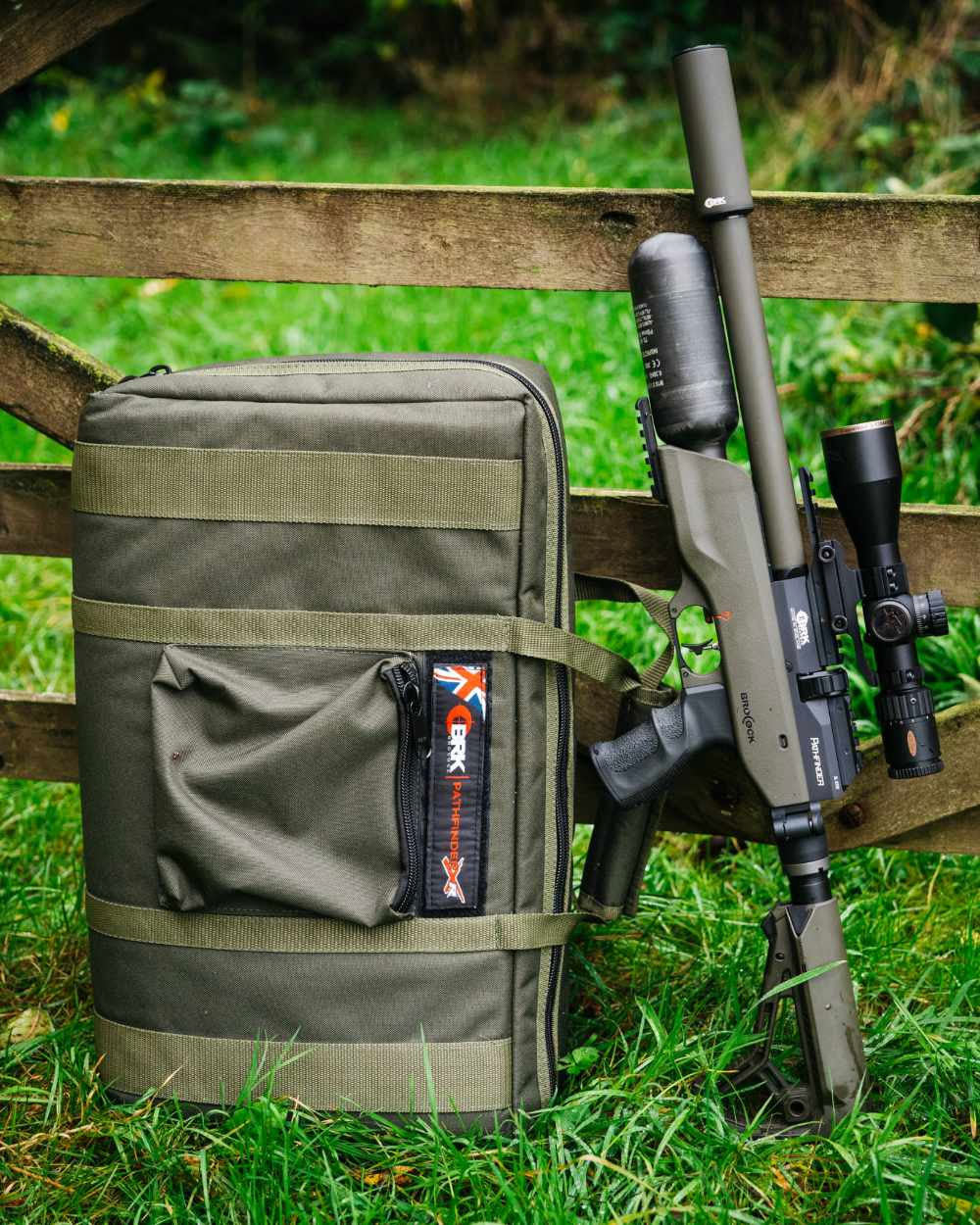 BRK Pathfinder green fitted with green BRK moderator stood with BRK Pathfinder bag in the field